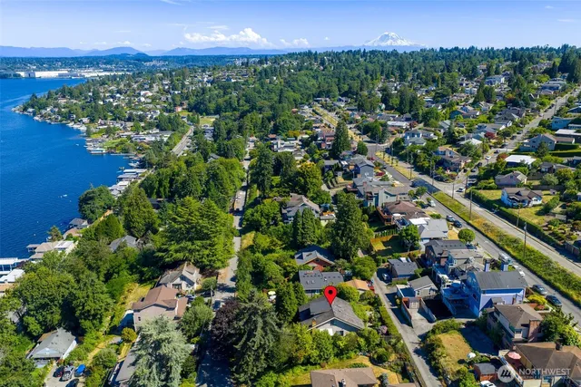 a hallway with a large window and wooden floor