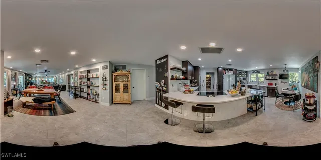 a view of a dining room with furniture a chandelier and wooden floor