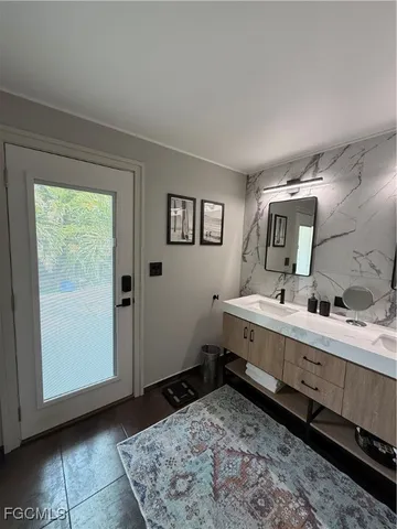 a bathroom with a sink toilet and mirror