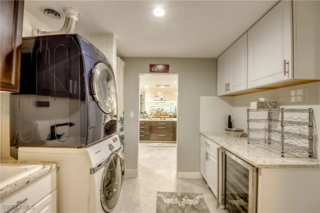 a view of washer and dryer with kitchen in the background