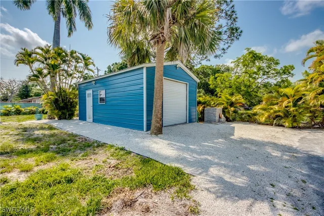 a view of a backyard with table and chairs and potted plants
