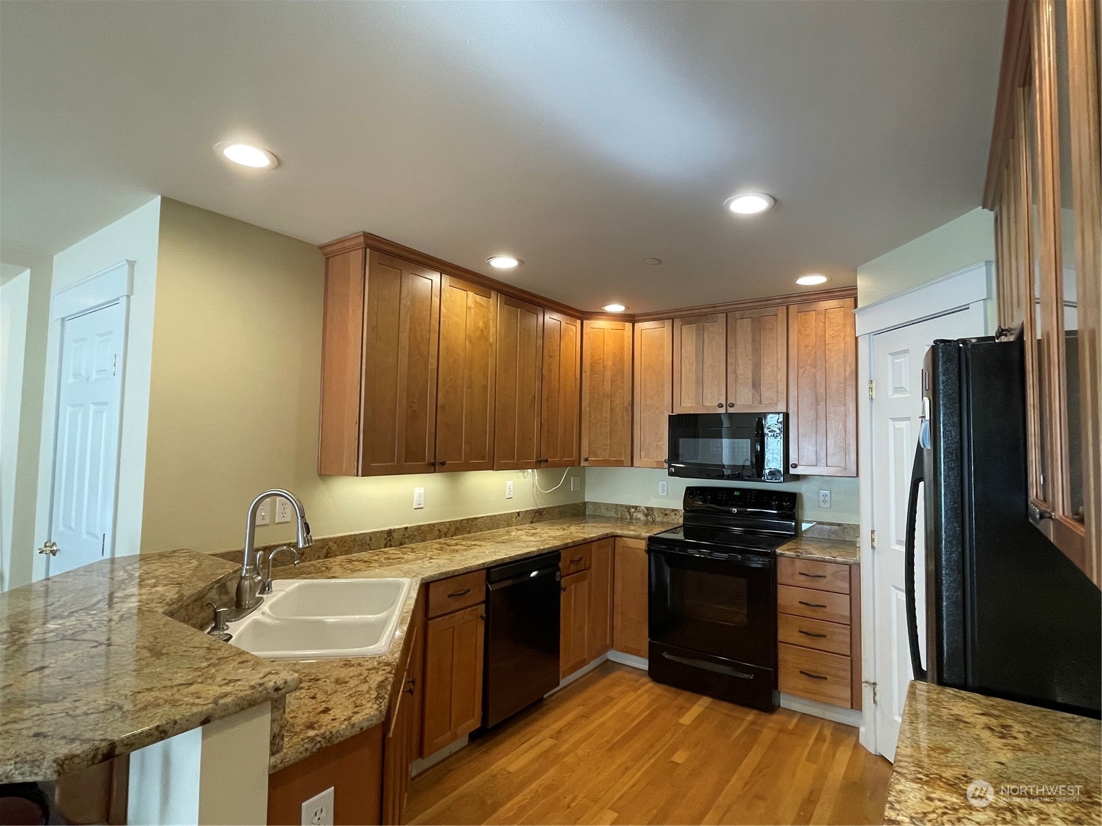 160 East Soderberg Road, Unit E15 Allyn, WA 98524 - Photo 13 of 33 a kitchen with granite countertop a sink cabinets and stainless steel appliances