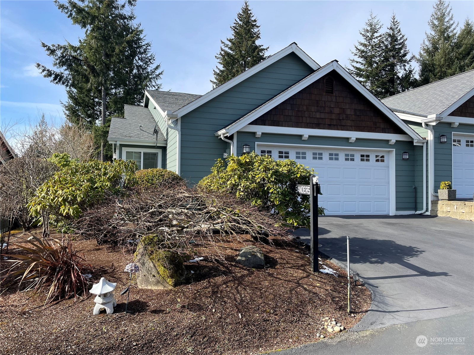 160 East Soderberg Road, Unit E15 Allyn, WA 98524 - Photo 2 of 33 a front view of a house with garden
