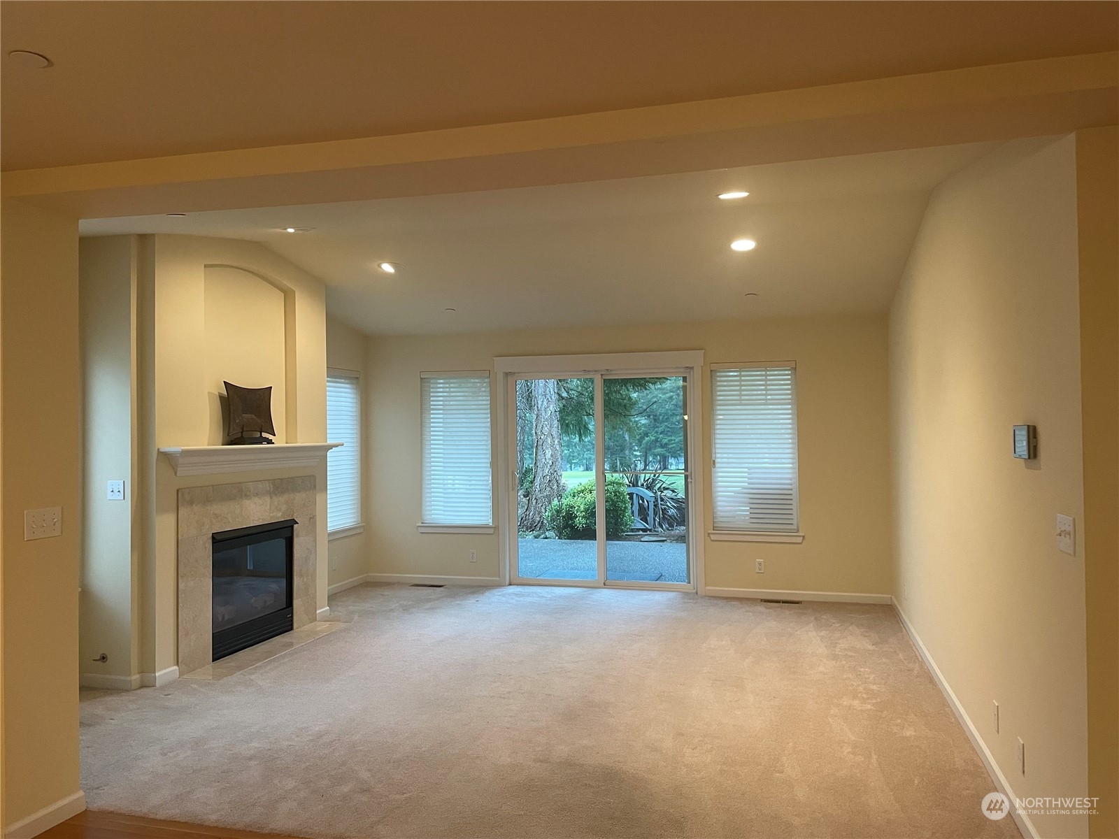 160 East Soderberg Road, Unit E15 Allyn, WA 98524 - Photo 9 of 33 a view of a livingroom with an empty space and a fireplace