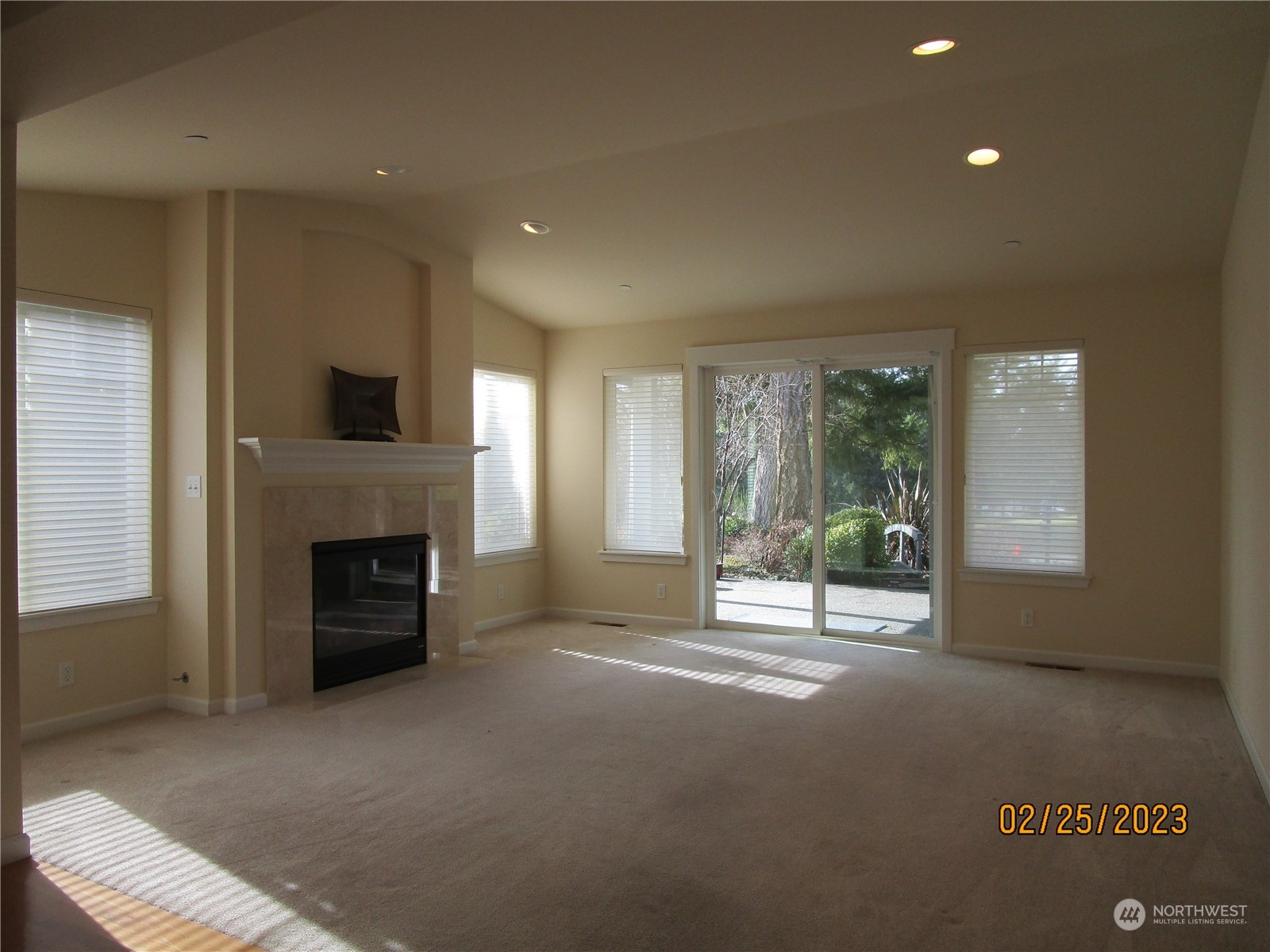 160 East Soderberg Road, Unit E15 Allyn, WA 98524 - Photo 10 of 33 a living room with a fireplace and a floor to ceiling window