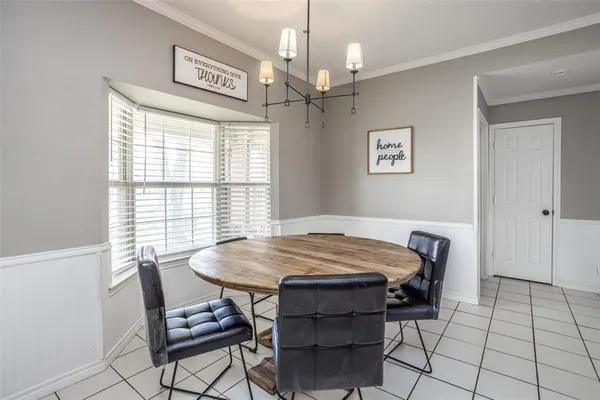 a bedroom with a table and chair