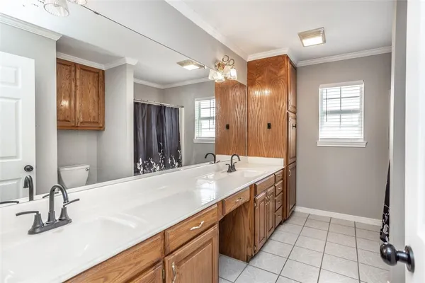 a bathroom with a granite countertop sink a mirror and a bathtub