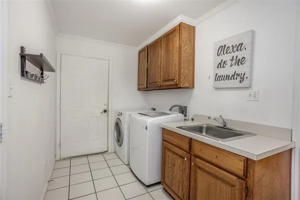 a utility room with sink dryer and washer