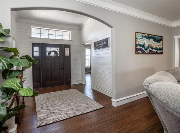 a view of livingroom with hallway and wooden floor