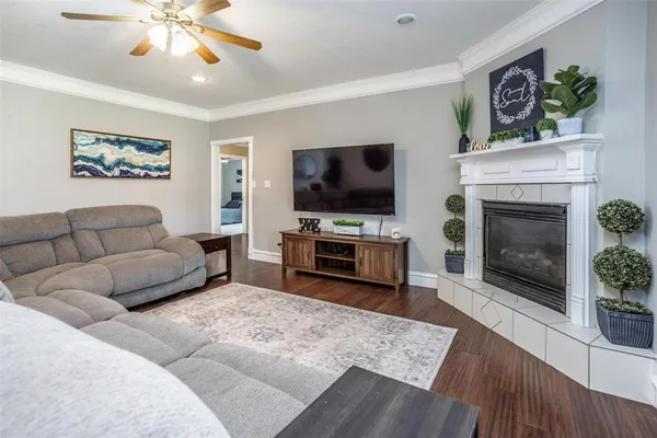 a living room with furniture a flat screen tv and a fireplace