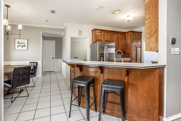 a kitchen with stainless steel appliances granite countertop a sink and a refrigerator