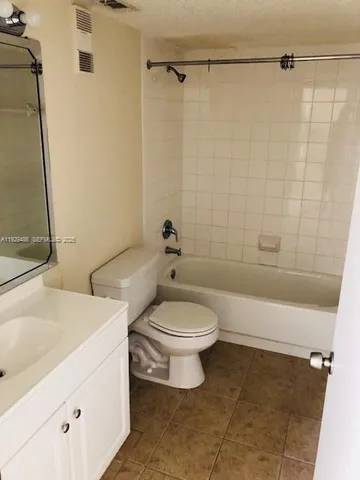 a living room with fireplace furniture and a large window