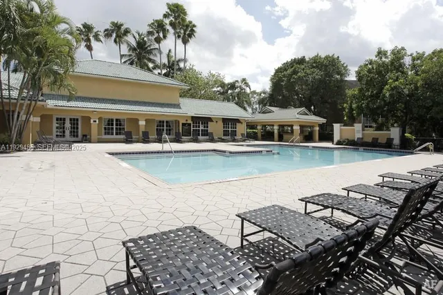 a view of a sign board with buildings in the background