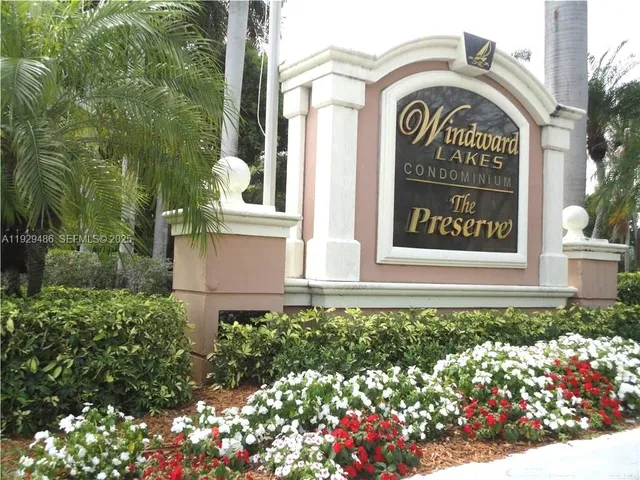 a front view of a house with a garden and trees