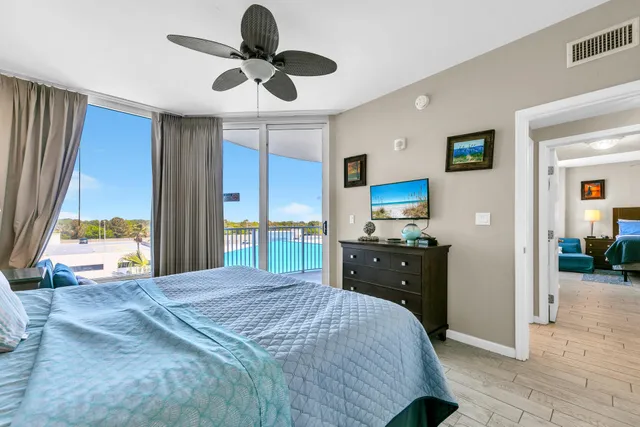 a bedroom with a bed a window and a chandelier