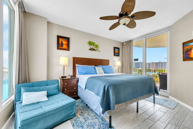 a bedroom with a bed a couch and a chandelier