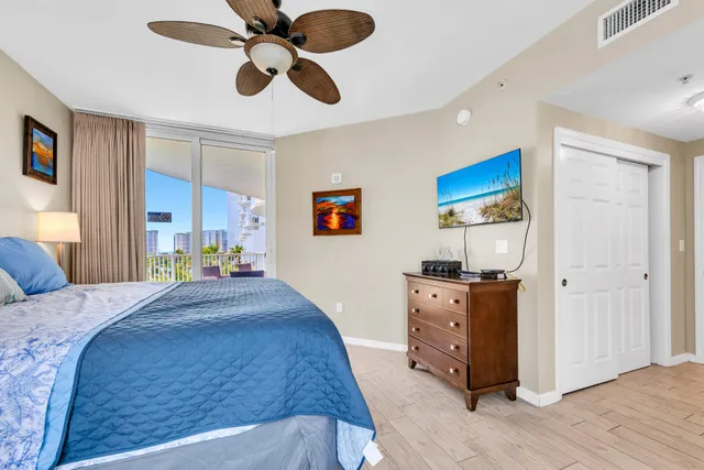 a spacious bedroom with a bed and a dresser