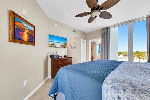 a bed room with a bed and a painting on the wall