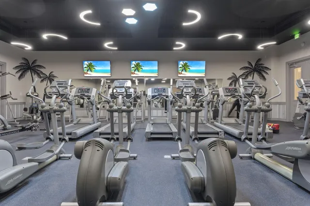 a living room with stainless steel appliances kitchen island granite countertop swimming pool and a large window