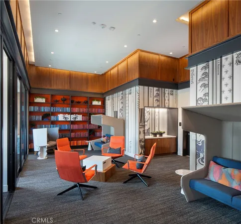 a living room with furniture a rug and a book shelf
