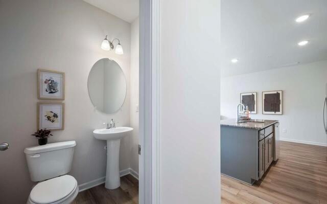 1380 Riverstone Road Jonesboro, GA 30238 - Photo 15 of 18 a bathroom with a toilet a sink and mirror