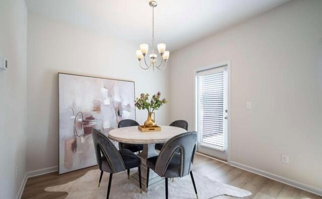 1380 Riverstone Road Jonesboro, GA 30238 - Photo 6 of 18 a view of a dining room with furniture a chandelier and wooden floor