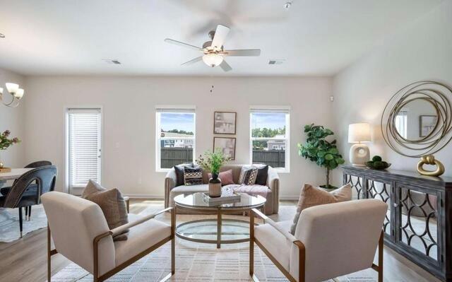 1380 Riverstone Road Jonesboro, GA 30238 - Photo 8 of 18 a living room with furniture a chandelier and a window