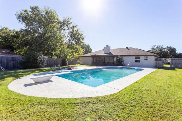 a view of a swimming pool with a yard