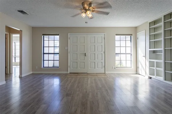 wooden floor in an empty room with a window and wooden floor