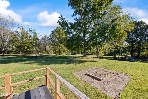 a view of a backyard with large trees