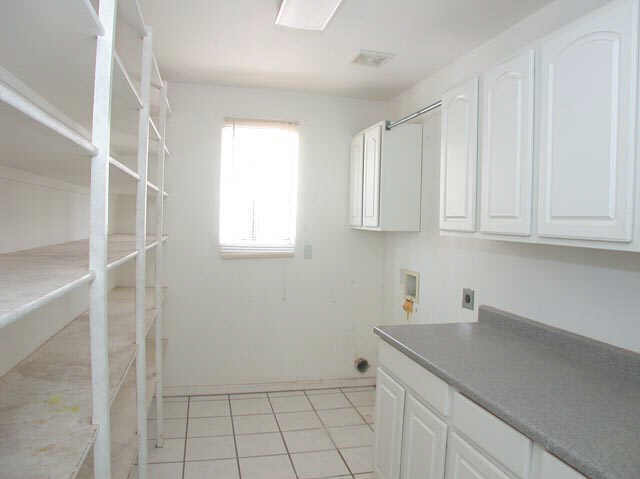 128 North Signal Butte Road Apache Junction, AZ 85120 - Photo 4 of 6 a kitchen with white cabinets and a window