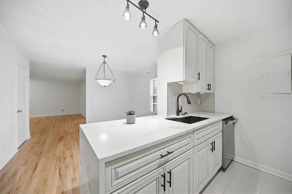 a kitchen with a sink and cabinets