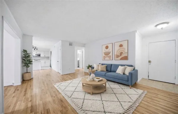 a living room with furniture and wooden floor