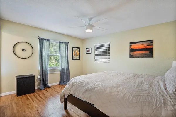 a bedroom with a bed and wooden floor