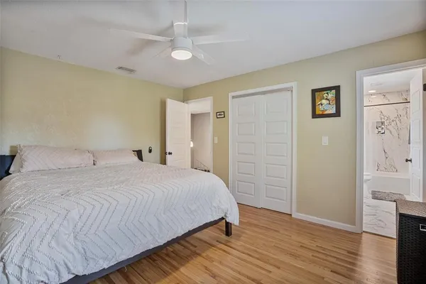 a bedroom with furniture and a wooden floors