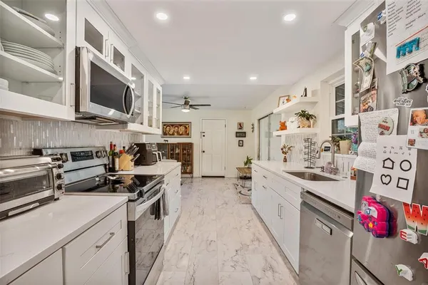 a kitchen with stainless steel appliances granite countertop a stove sink and cabinets