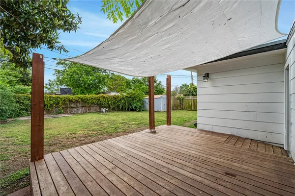a view of a backyard with wooden floor and floor to ceiling window