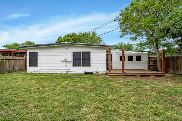 a backyard of a house with table and chairs