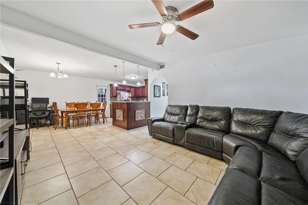 a living room with furniture and kitchen view