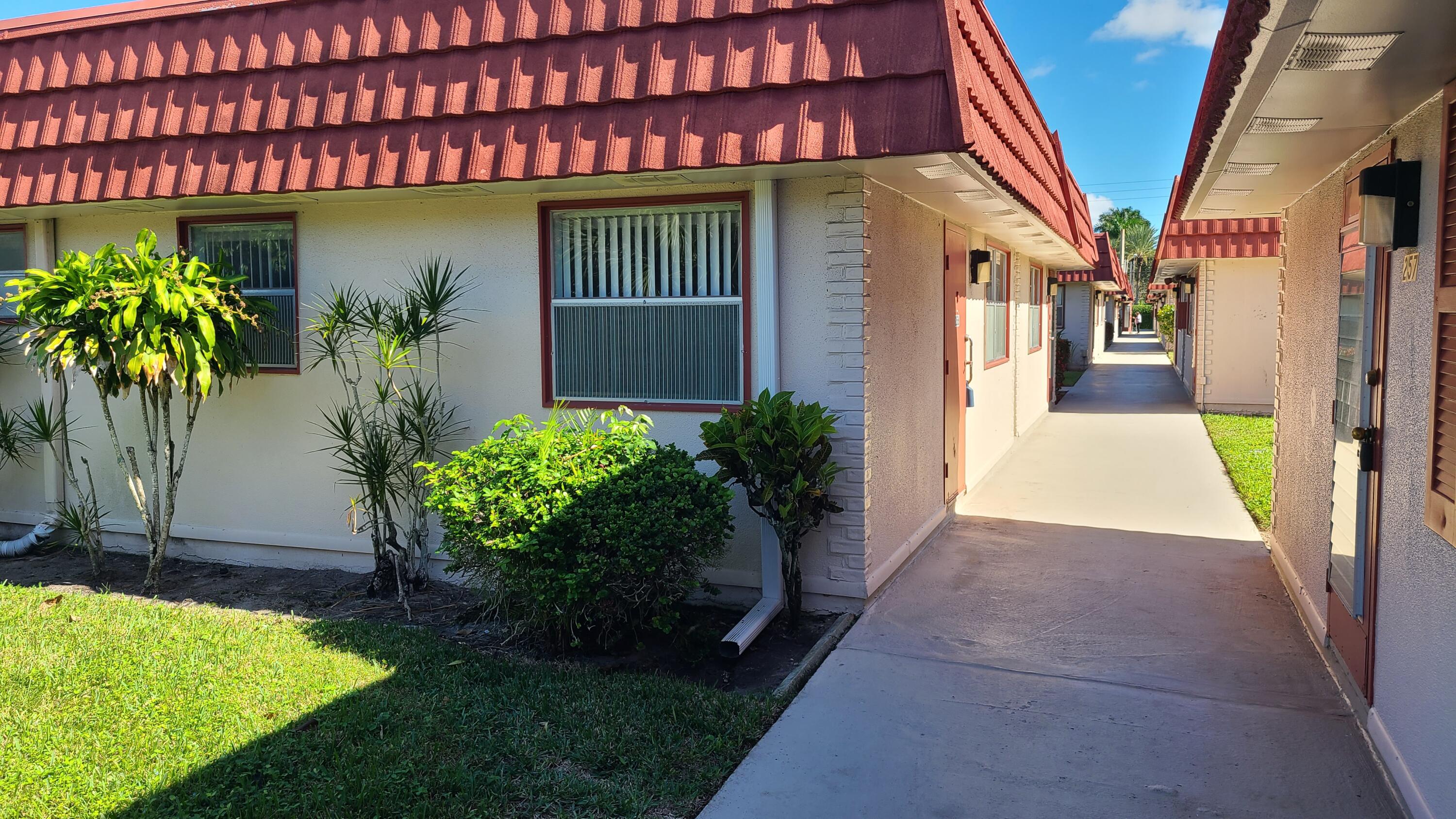 a view of a house with potted plants