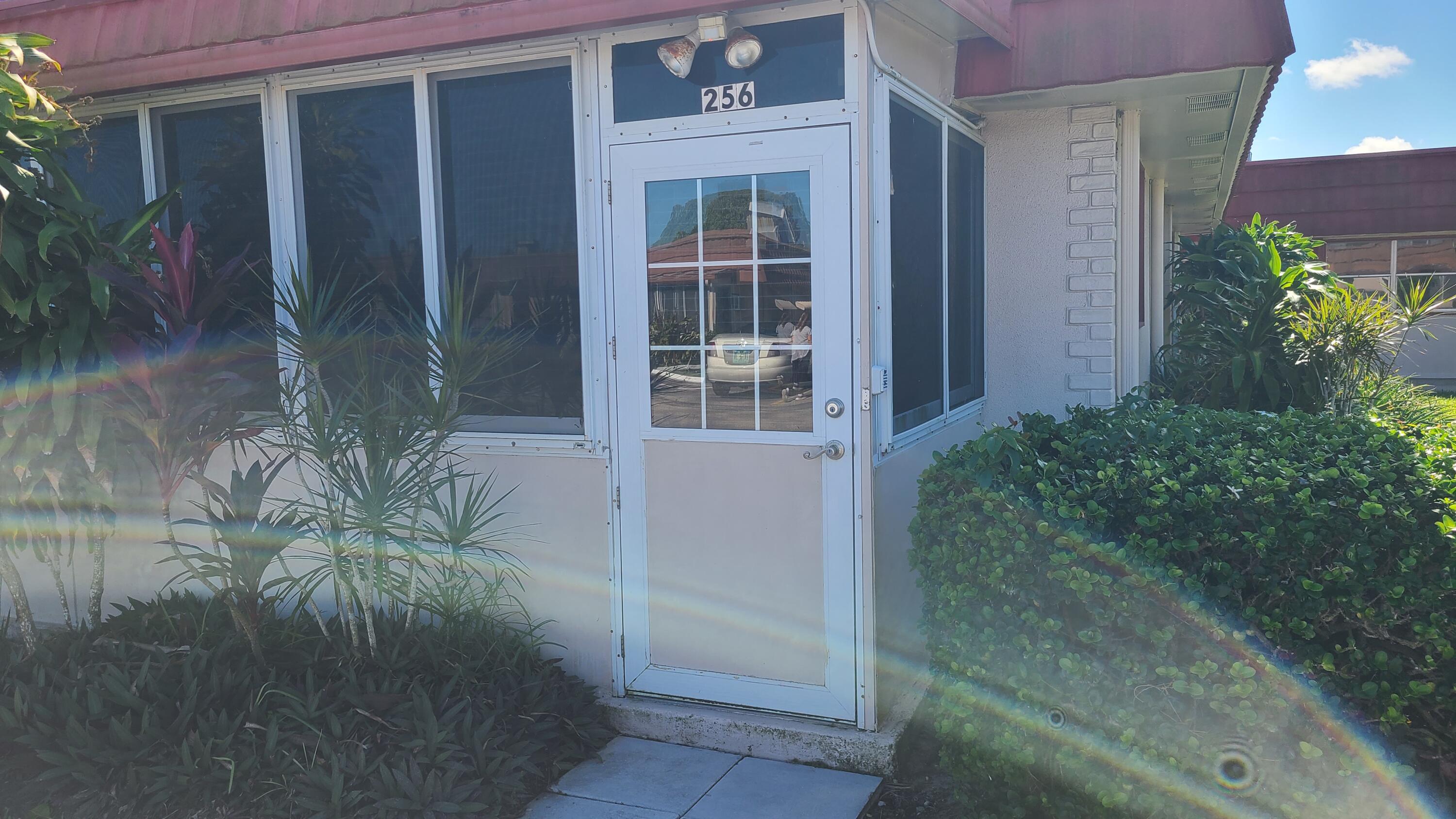 256 Seville K Delray Beach, FL 33446 - Photo 20 of 45 a potted plant in front of a door