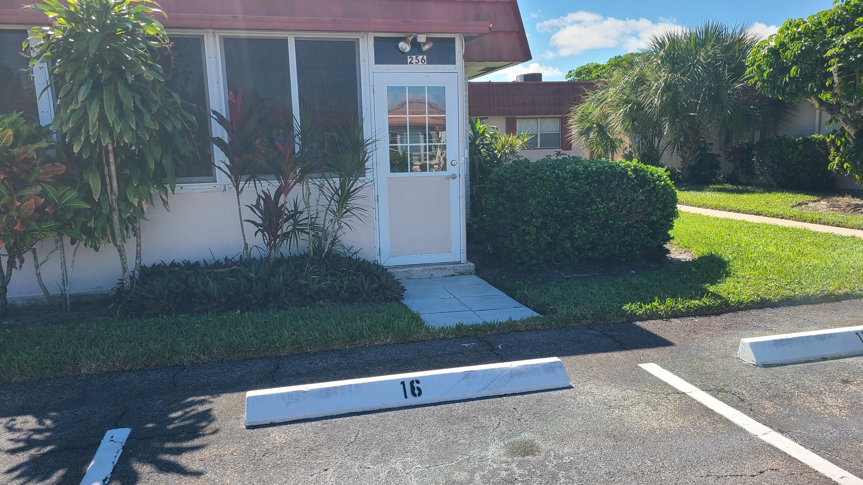 256 Seville K Delray Beach, FL 33446 - Photo 21 of 45 front view of a house with a yard
