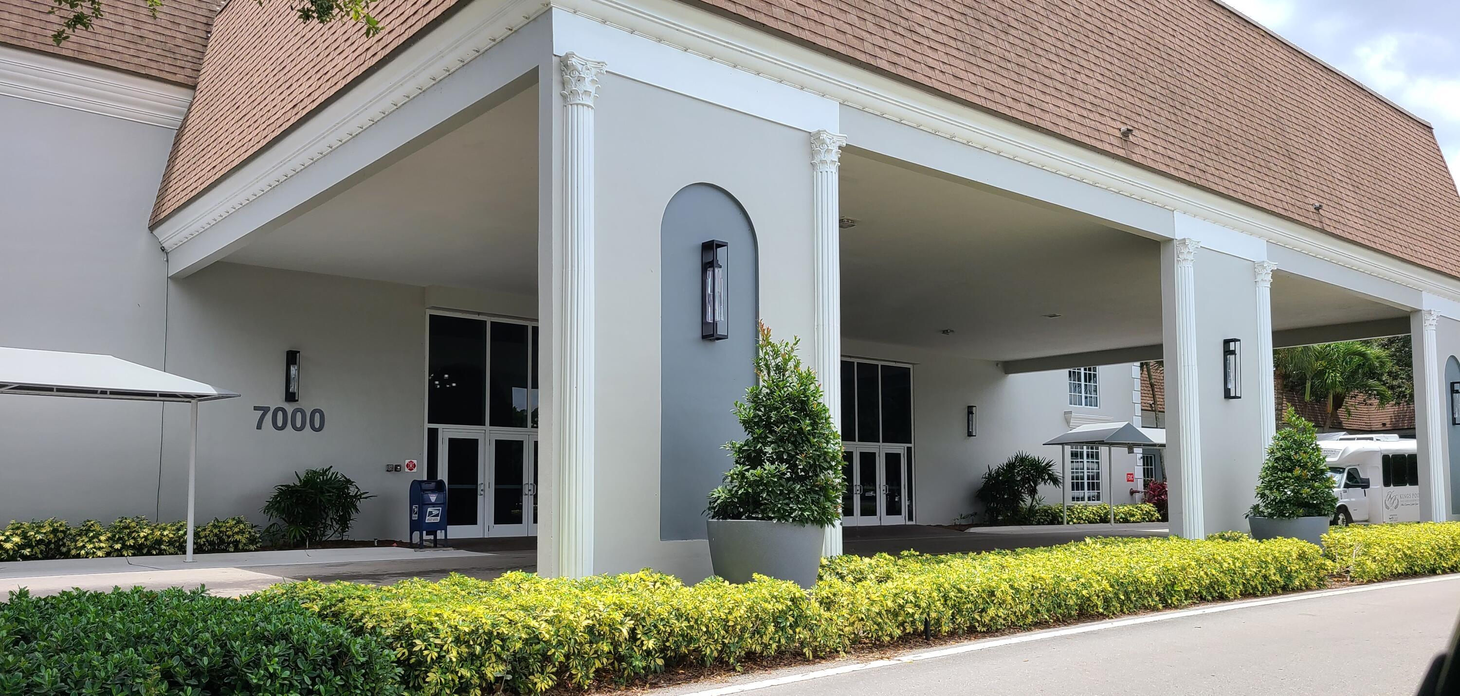 256 Seville K Delray Beach, FL 33446 - Photo 24 of 45 a front view of a house with garden