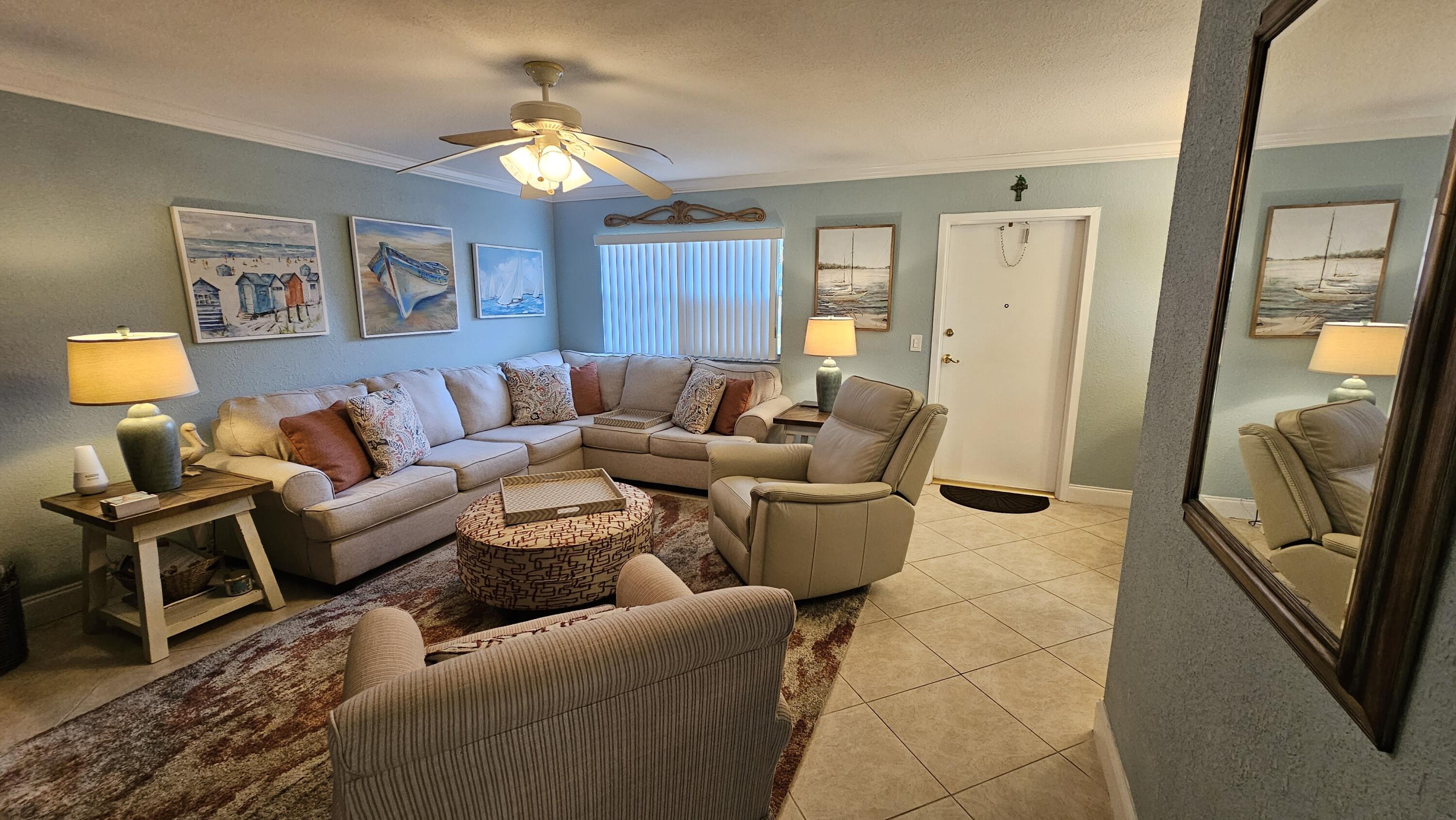 256 Seville K Delray Beach, FL 33446 - Photo 3 of 45 a living room with furniture and a flat screen tv