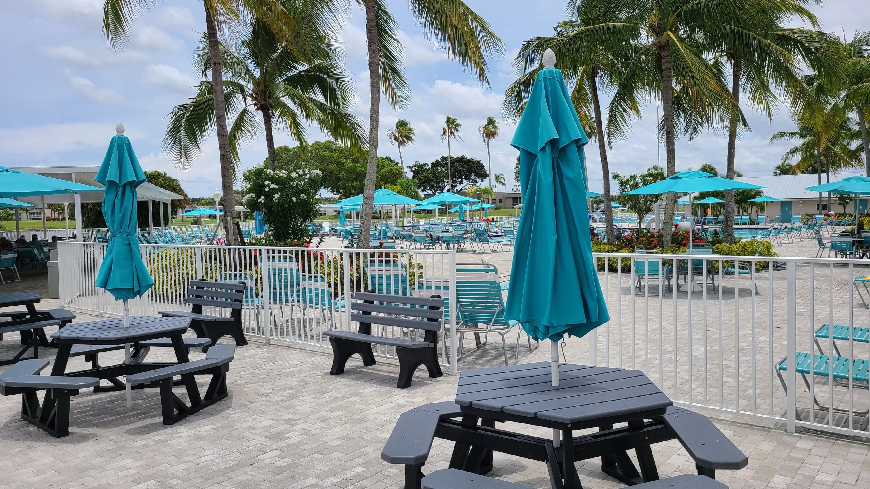 256 Seville K Delray Beach, FL 33446 - Photo 37 of 45 a view of a patio with a table chairs and a potted plant
