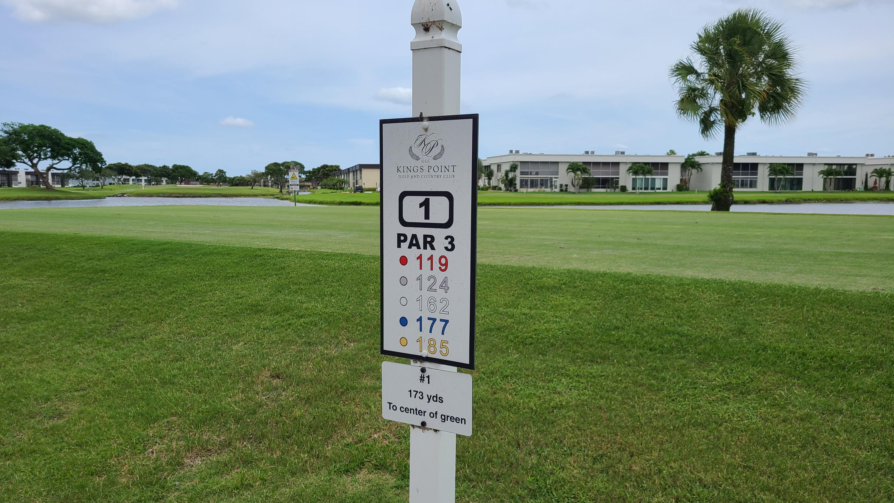 256 Seville K Delray Beach, FL 33446 - Photo 40 of 45 a sign board with a play ground in the back