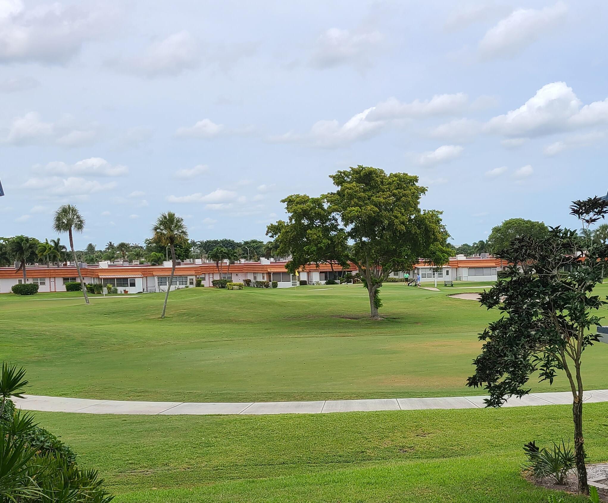 256 Seville K Delray Beach, FL 33446 - Photo 42 of 45 a view of a golf course with a lake