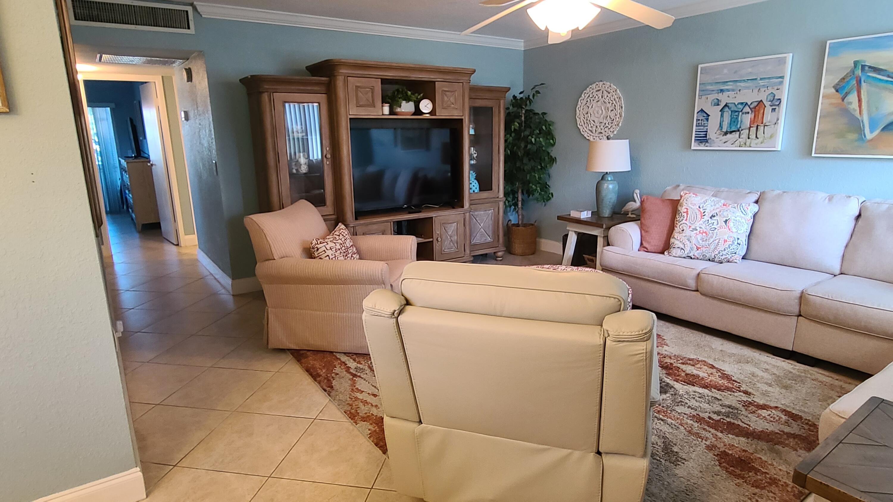 256 Seville K Delray Beach, FL 33446 - Photo 5 of 45 a living room with furniture and a flat screen tv