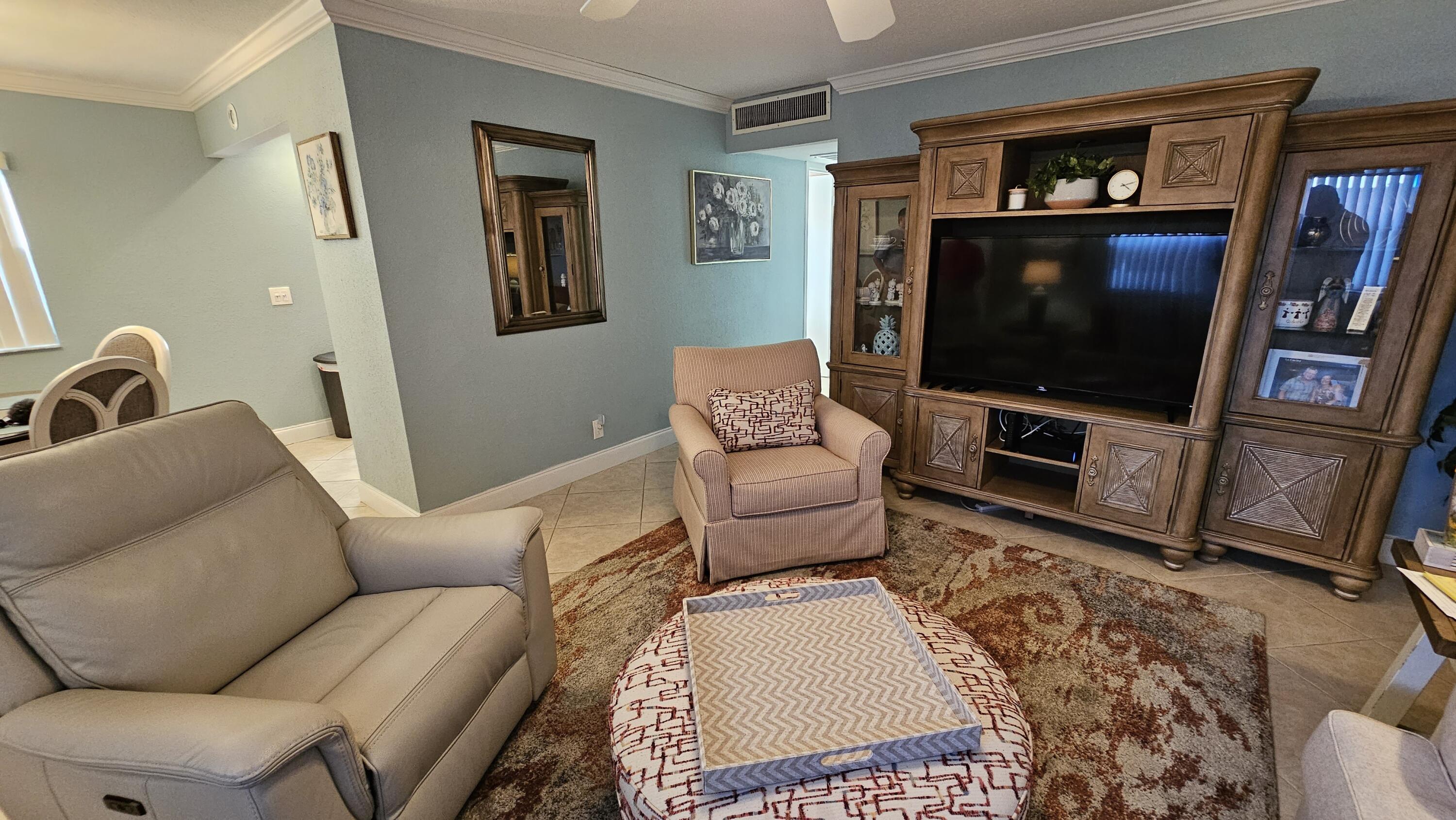 256 Seville K Delray Beach, FL 33446 - Photo 6 of 45 a living room with furniture and a flat screen tv