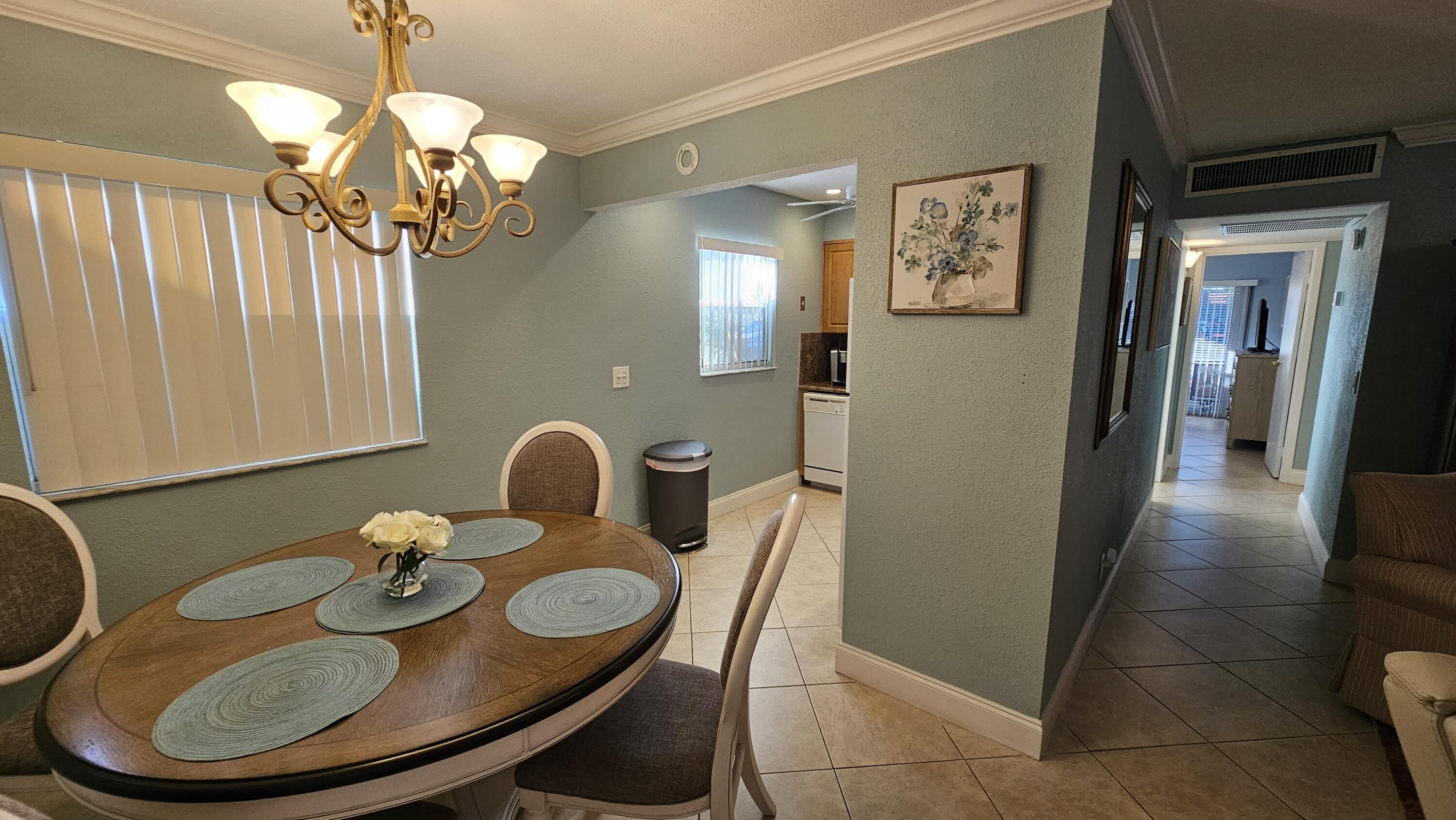 256 Seville K Delray Beach, FL 33446 - Photo 8 of 45 a view of a dining room with furniture and chandelier